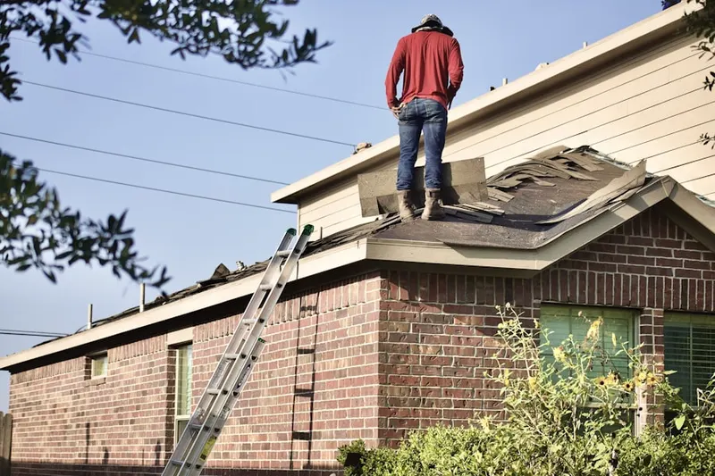 Professional roofer working on a residential roof in Lakepointe